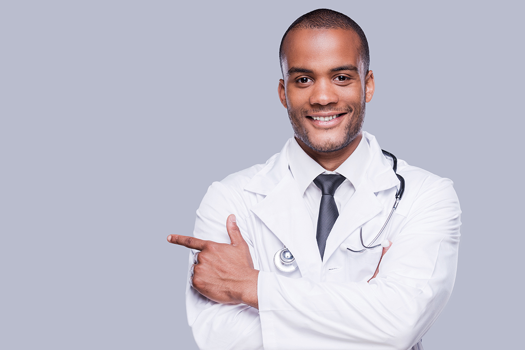 Confident Male Doctor. Cheerful African Doctor Pointing Away And - Advance Soluções Empresariais e Contabilidade
