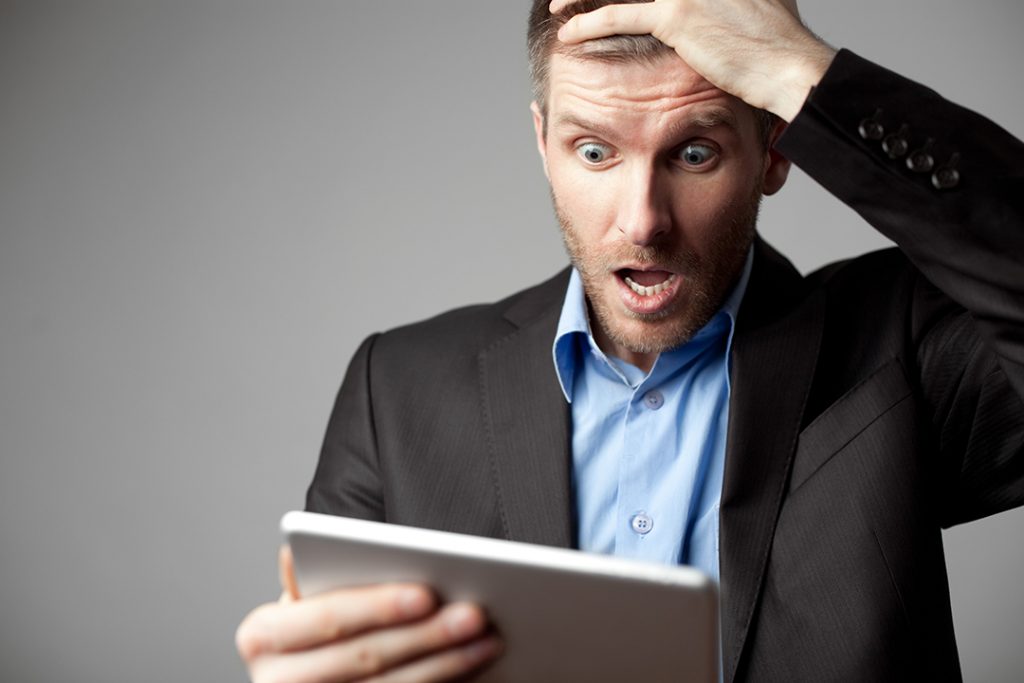 Shocked Businessman With Digital Tablet - Advance Soluções Empresariais e Contabilidade